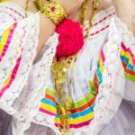 Folklore - Selective Focus Photography of Woman Holding Floral Hairpiece