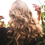 Highlights - Blonde-haired Woman Standing Between Green Plants