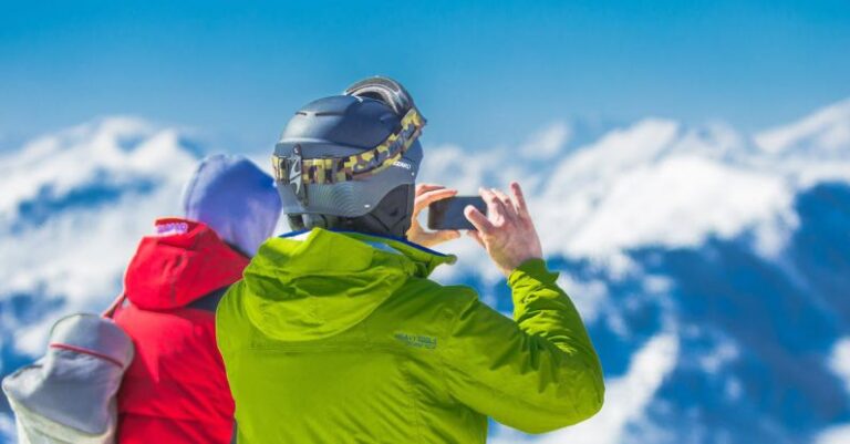 Tours - Man in Green Jacket and Gray Helmet Holding Phone Standing Next to Person in Red and Black Jacket