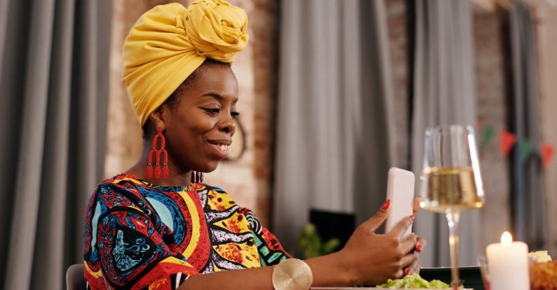 Traditions - Photo Of Woman Looking At Her Phone