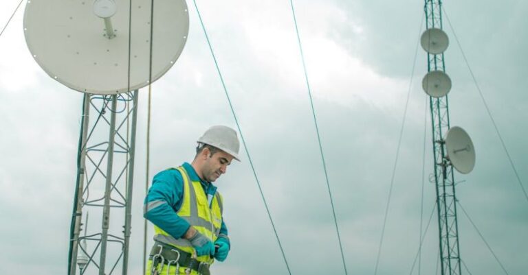 Installations - Worker Walking near Satellites