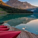 Landscapes - Red Canoes on Sea Dock Near Calm Body of Water