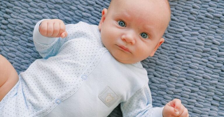 Beauty - Baby in White Onesie Lying on Grey Textile