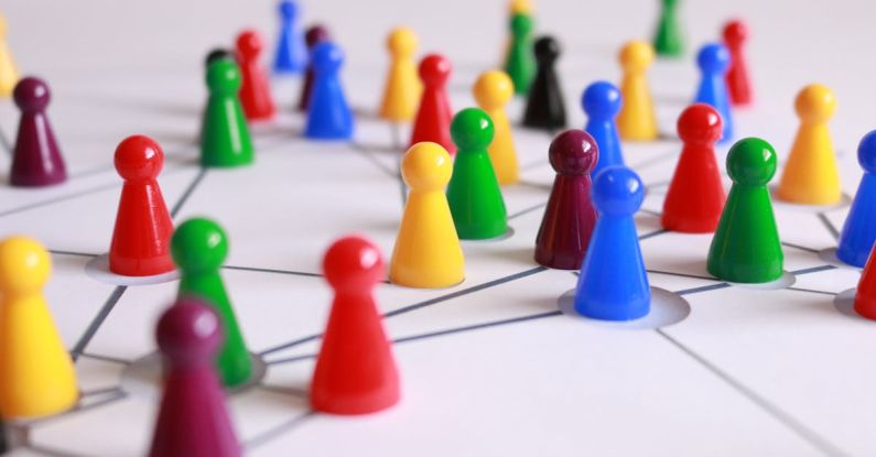 Figures - Close Up Photography of Yellow Green Red and Brown Plastic Cones on White Lined Surface