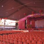 Venues - A large tent with orange chairs and red carpet